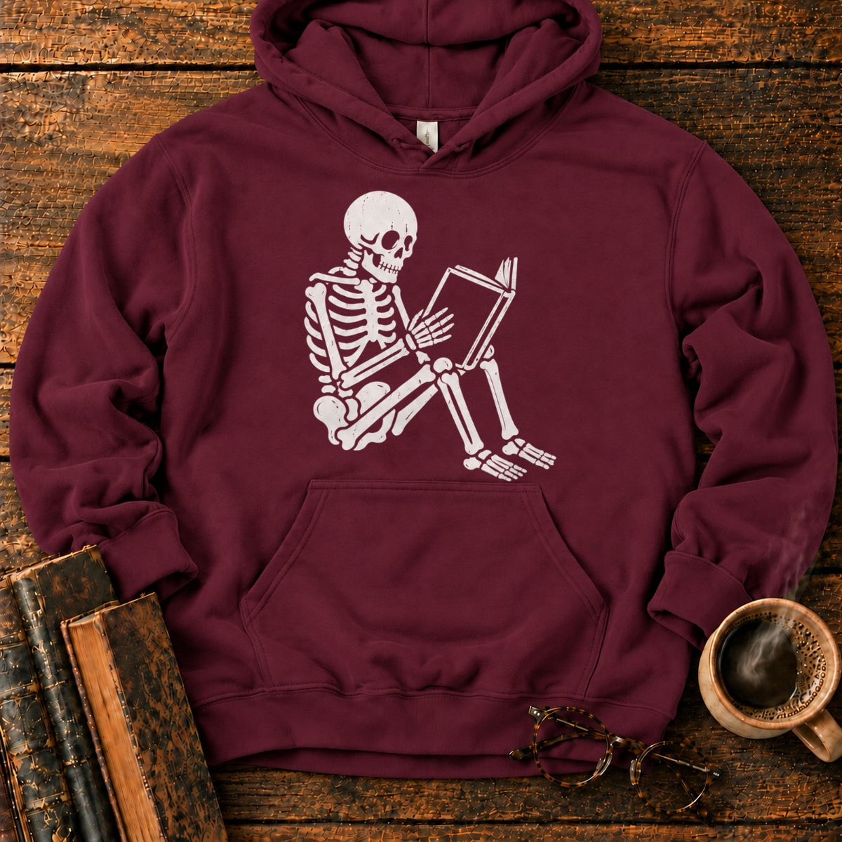 Seated Skeleton Reading An Open Book Hoodie in Maroon – BooksThreads