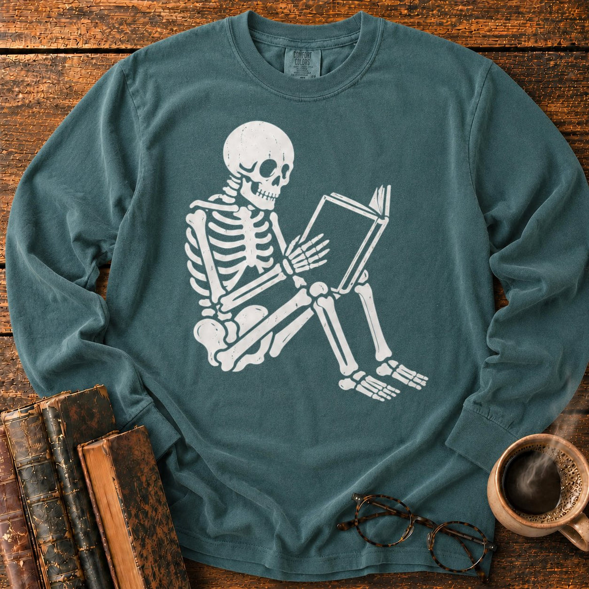 Seated Skeleton Reading An Open Book LS T-Shirt in Blue Spruce – BooksThreads